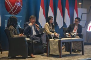 Panelists in discussion at the ESG Summit, including a representative from the Ministry of State-Owned Enterprises and the Singaporean Ambassador. The backdrop includes the Indonesian flags and the logo of the Indonesia Stock Exchange (IDX)